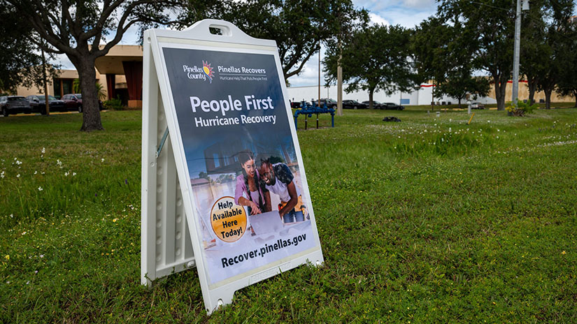 People First Hurricane Recovery sign announces Help Available Here Today outside a popup help location.
