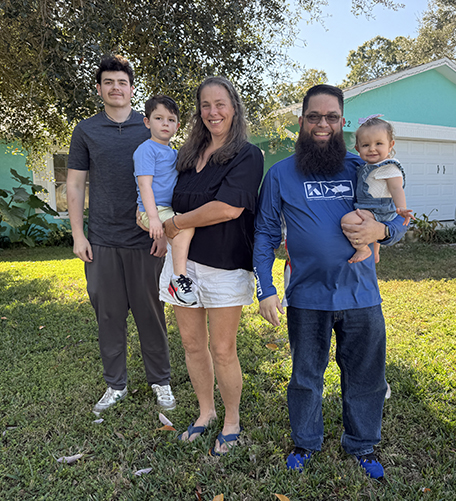 the Piccion family poses outside their home