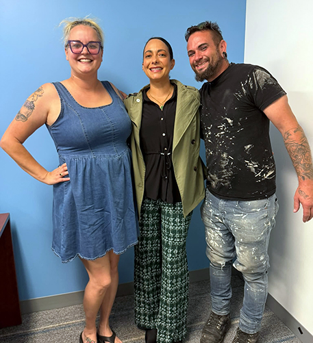 Jess and Christopher poses with Pinellas Recovers staff to celebrate the recovery help they received.